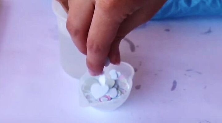 how to make cute diy valentine earrings with resin heart confetti, Adding heart confetti to the resin