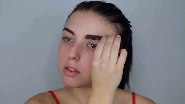 how to do effortlessly sexy red valentine s day makeup, Setting brows in place with brow gel