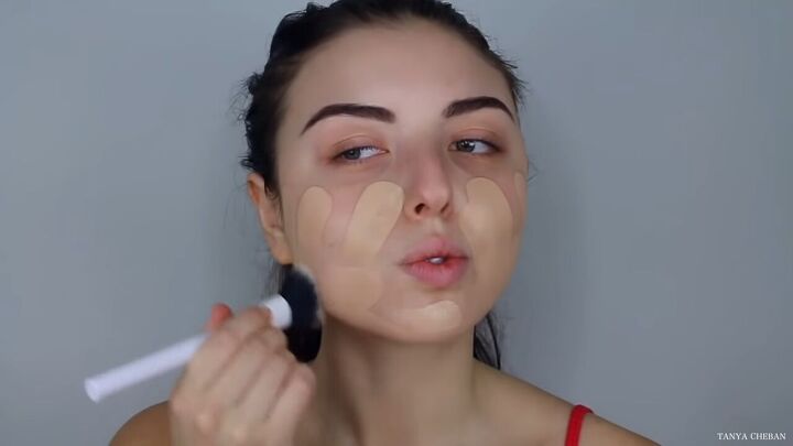 how to do effortlessly sexy red valentine s day makeup, Applying foundation with a makeup brush