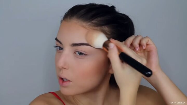how to do effortlessly sexy red valentine s day makeup, Applying a shimmery bronzer