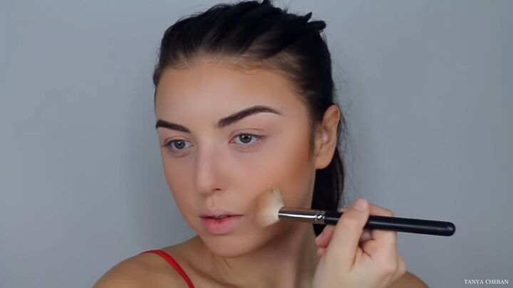 how to do effortlessly sexy red valentine s day makeup, Sculpting cheekbones with bronzer
