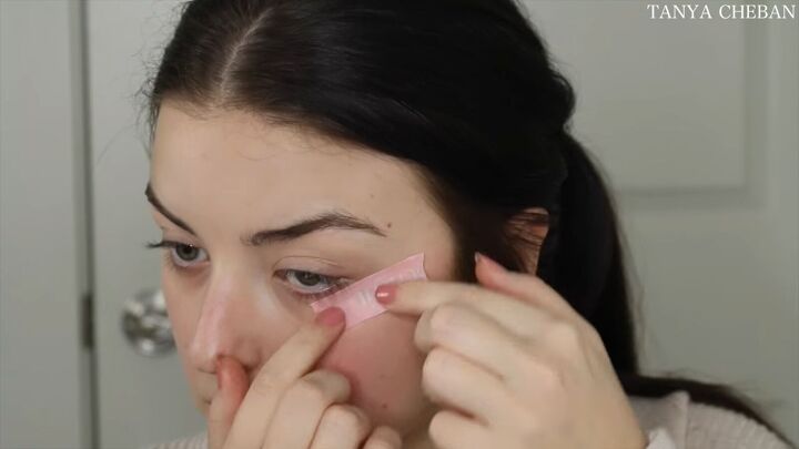 how to do simple valentines day makeup for a soft feminine vibe, Applying tape before eye makeup