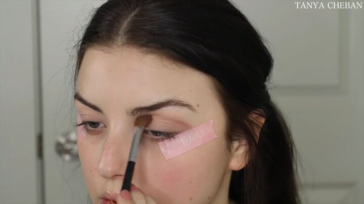 how to do simple valentines day makeup for a soft feminine vibe, Applying a dark dusty pink to the crease