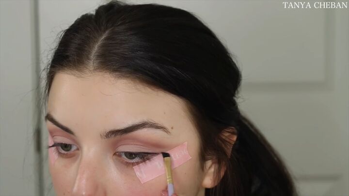 how to do simple valentines day makeup for a soft feminine vibe, Creating a wing with gel liner and tape