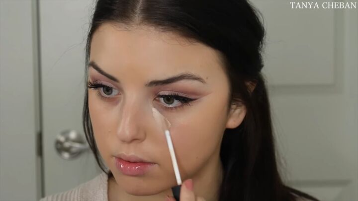 how to do simple valentines day makeup for a soft feminine vibe, Applying concealer under the eyes
