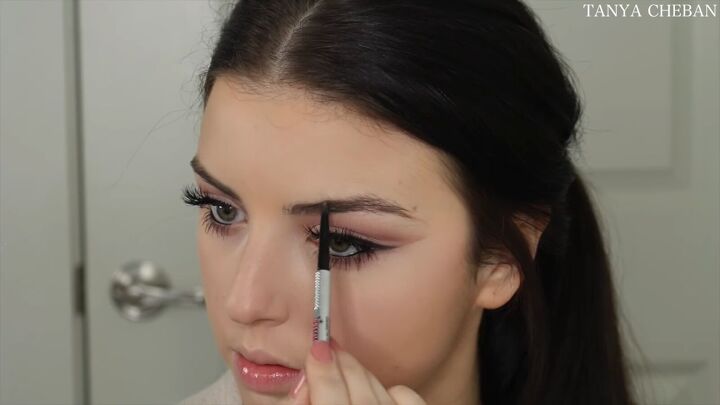 how to do simple valentines day makeup for a soft feminine vibe, Filling in brows with a brow pencil