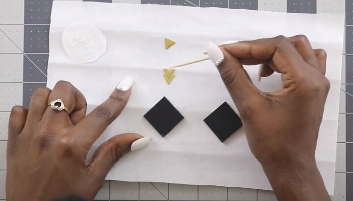 how to make africa earrings in 3 quick easy steps, Using jewelry glue to attach the triangles