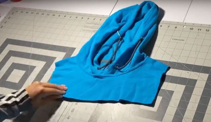 how to easily make your own color block hoodie with patchwork pieces, Cutting the sides and bottom off the hoodi