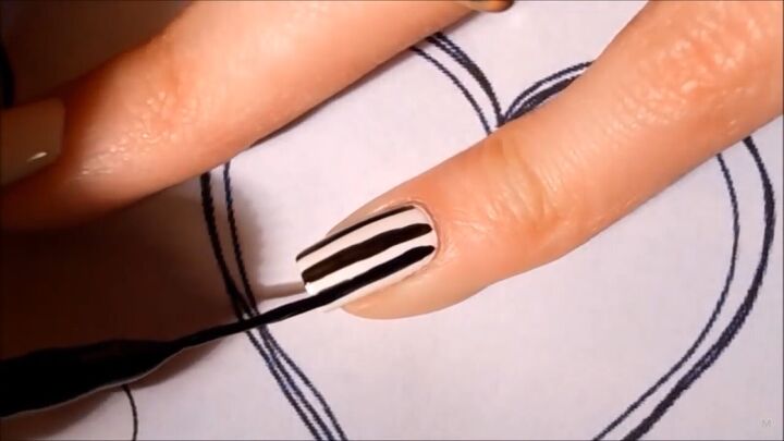 get in the mood for love with this black white valentine s nail art, Using black striper polish on a white nail