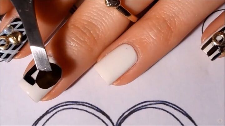get in the mood for love with this black white valentine s nail art, Applying top coat and sticking the letters