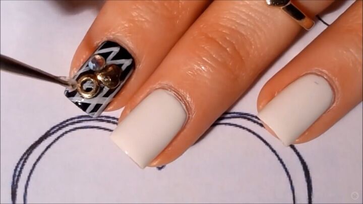 get in the mood for love with this black white valentine s nail art, Applying studs and jewels to nails