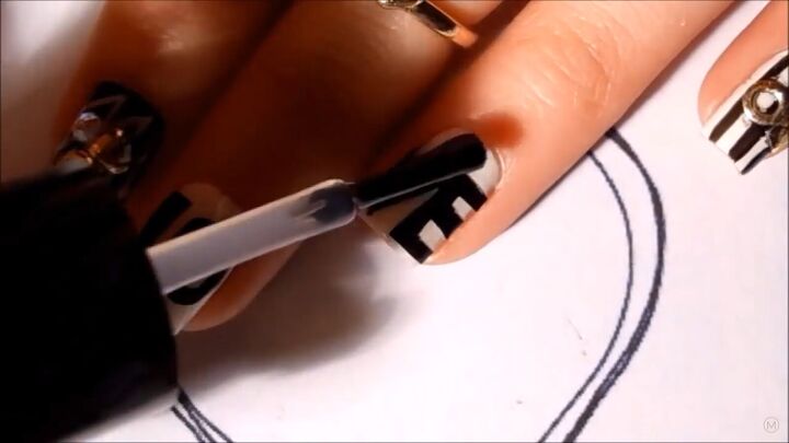 get in the mood for love with this black white valentine s nail art, Sealing the Valentine s nails with top coat