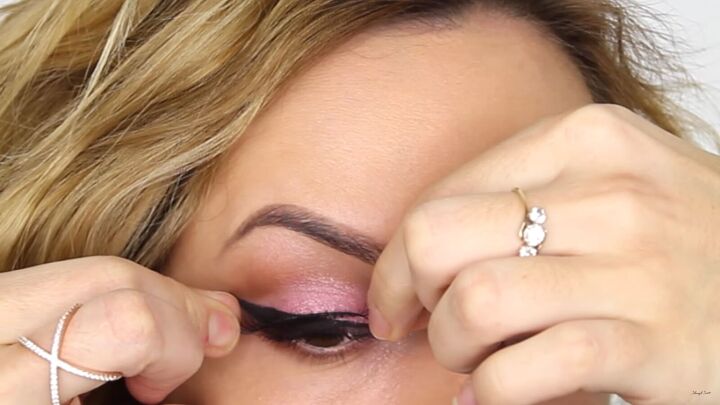 how to create a cool pink eye lip makeup look for valentines day, Applying false lashes over pink eye makeup