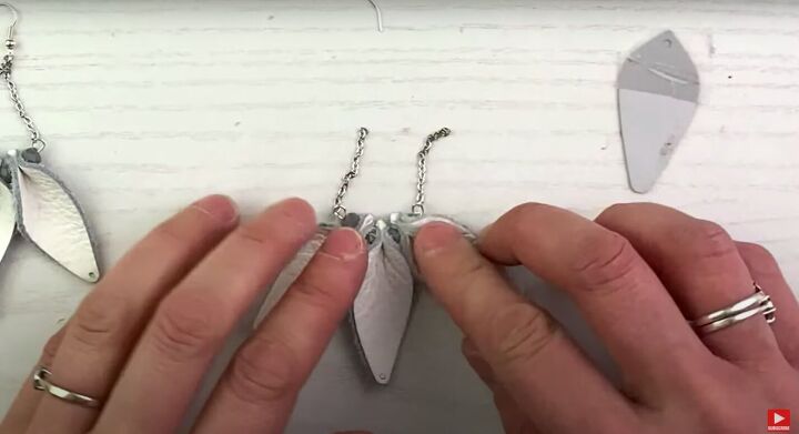 how to make cute diy pinched leather earrings, Opening the rings and attaching the chains