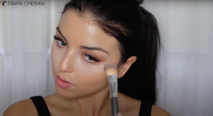 simple contouring highlighting baking routine for a natural glam, Applying highlight to the cheekbone area