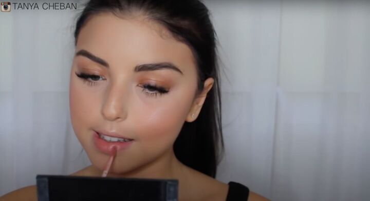 simple contouring highlighting baking routine for a natural glam, Applying a natural colored lipstick