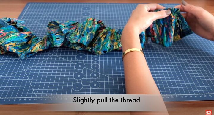 how to make a ruffle wrap skirt matching crop top from a maxi dress, Pulling the gathering stitch