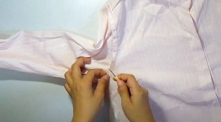 how to make a crop top with ruffles out of an old button down shirt, Using a seam ripper to remove the sleeves