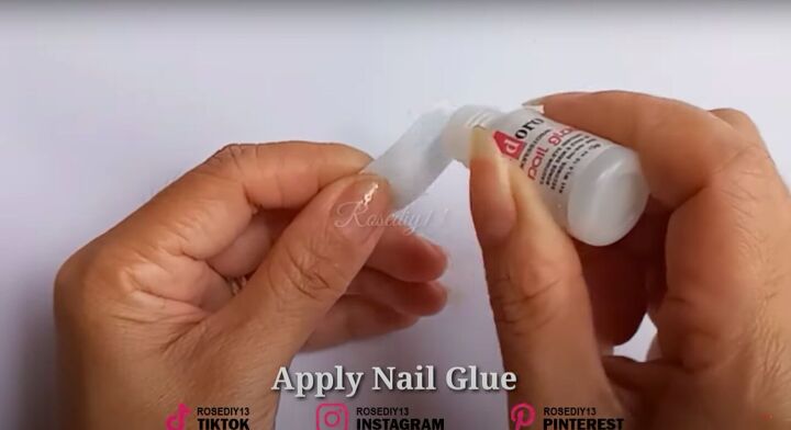 how to make diy fake nails out of a face mask baby powder, Applying nail glue to the face mask