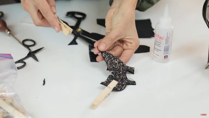 how to make stunning diy butterfly wing heels at home, Placing pegs on the wings while the glue dries