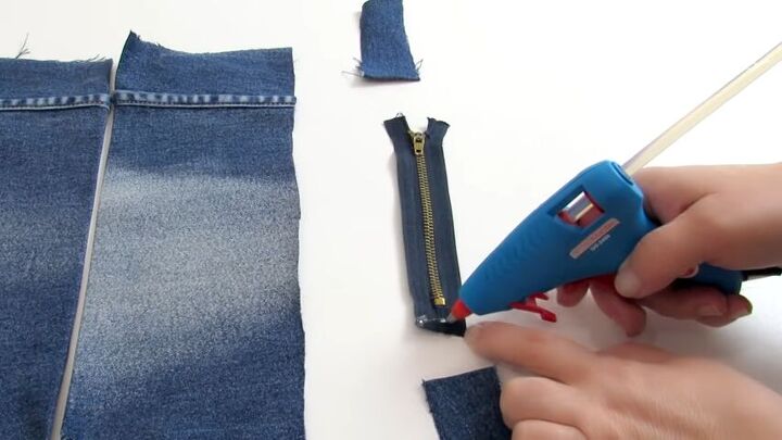 how to make a cute diy wrist wallet out of old jeans, Applying hot glue to the zipper