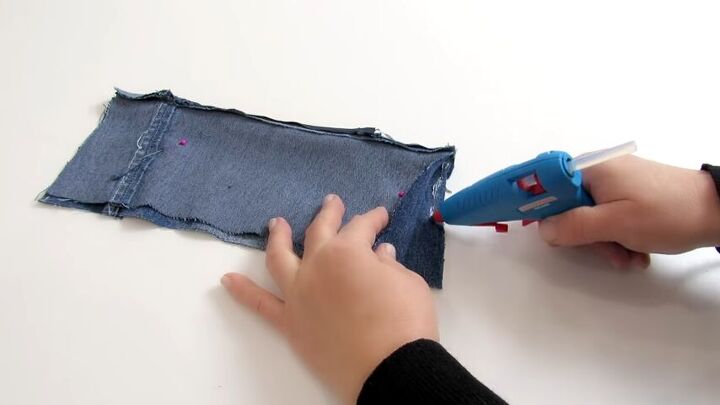 how to make a cute diy wrist wallet out of old jeans, Gluing the open edges