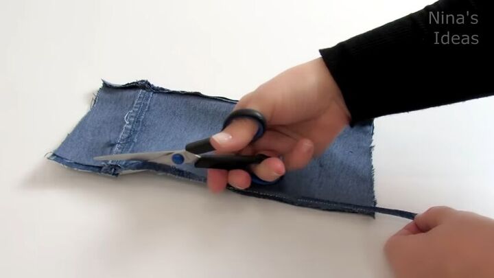 how to make a cute diy wrist wallet out of old jeans, Trimming the excess