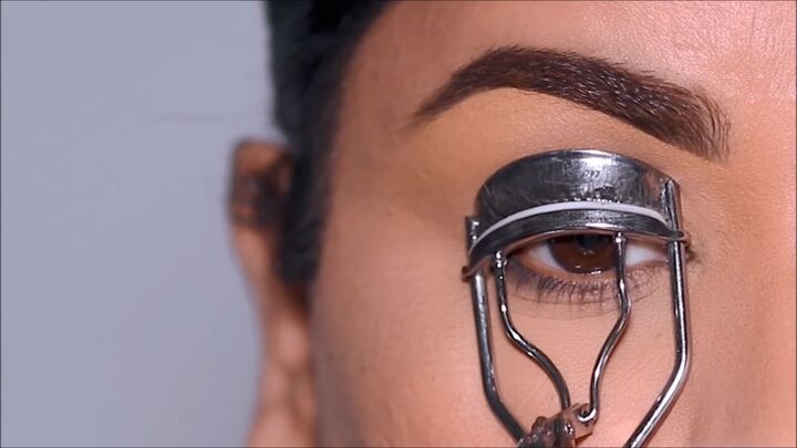 why puppy eyeliner works for hooded eyes how to do it, Curling eyelashes with an eyelash curler