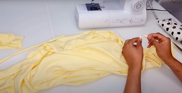 how to make an easy diy wrap dress you can wear different ways, Pinning the belt ties to the skirt