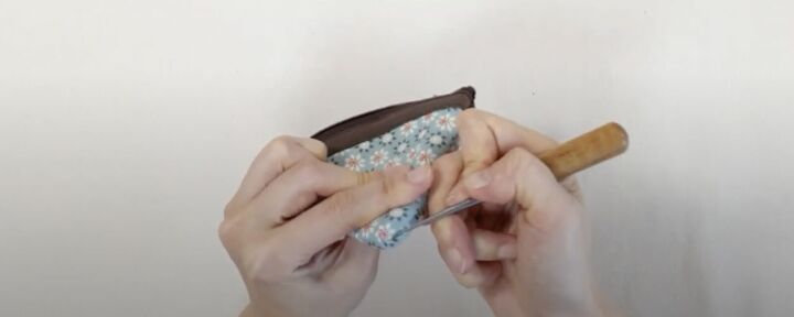 how to make a cute pizza or pie shaped diy coin purse, Using an awl to push the corners out