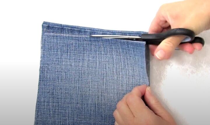 how to make a crossbody bag out of jeans without sewing, Cutting the denim below the seam