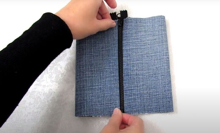 how to make a crossbody bag out of jeans without sewing, Gluing the denim to the zipper