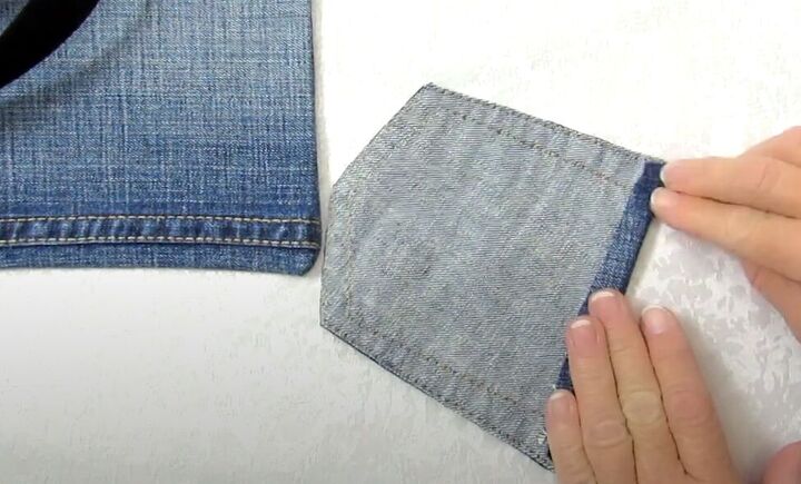 how to make a crossbody bag out of jeans without sewing, Gluing the top seam allowance in place