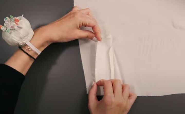 how to easily sew a sleeve placket and cuff in a few simple steps, Folding the long edges of the placket ready to press
