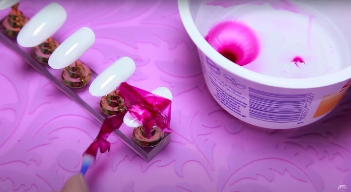 how to create delicate flower petal nail art with water nail polish, Applying the nail polish piece to the nail