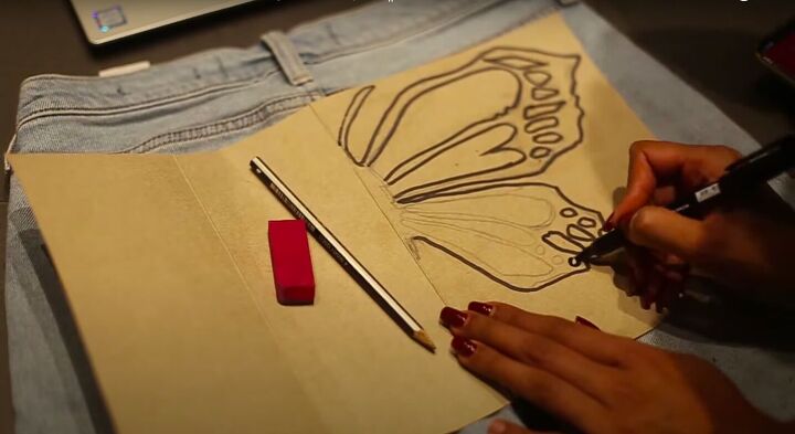 how to create a beautiful butterfly bleach design on jeans, Going over the butterfly wing design with a marker