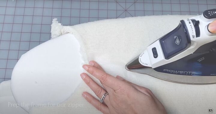 how to sew a sweater with a cute cropped hem half zipper, Pressing the interfacing