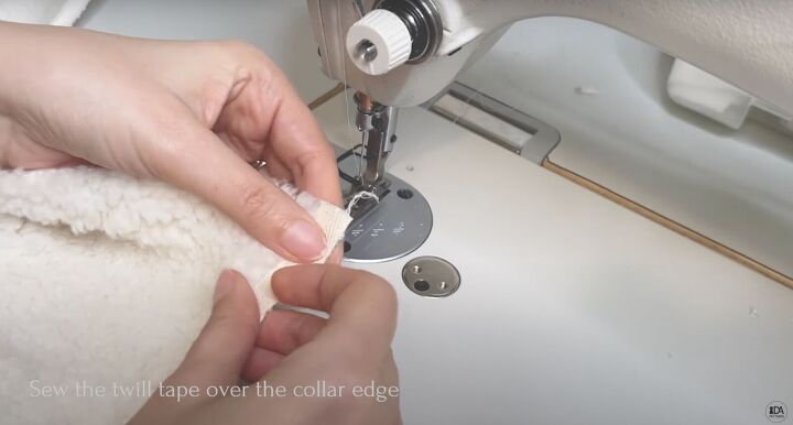 how to sew a sweater with a cute cropped hem half zipper, Placing the twill tape on the collar