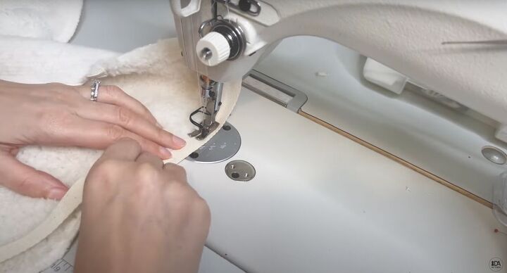 how to sew a sweater with a cute cropped hem half zipper, Sewing the twill tape to the collar