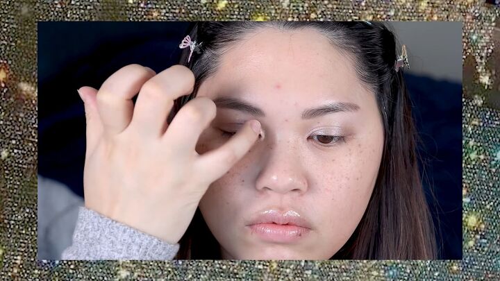put a spin on 90s makeup with this fun 1990s inspired makeup tutorial, Applying the gold champagne colored eyeshadow to the inner corners of the eyes