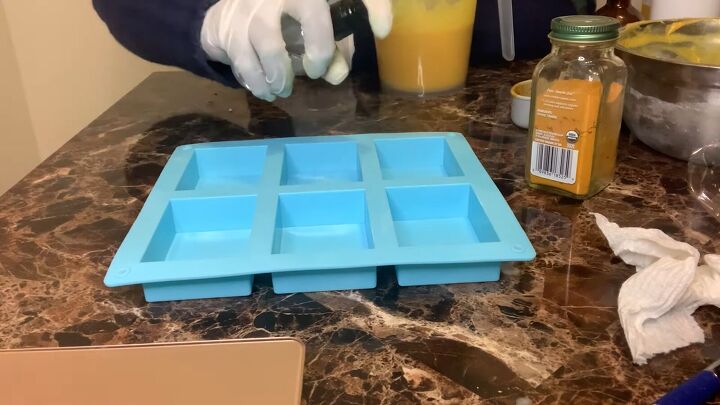 how to make a turmeric honey soap bar using a melt pour base, Spraying the soap mold with alcohol spray