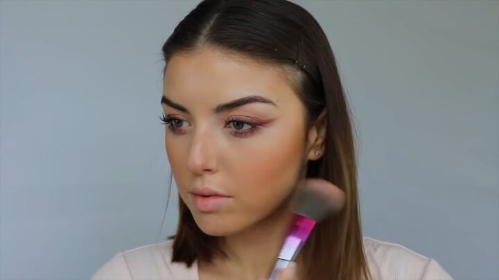 how to create a sweet soft glowy spring makeup look, Applying a pretty spring colored blush to the cheeks