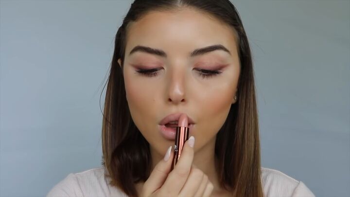 how to create a sweet soft glowy spring makeup look, Applying a subtle nude lipstick