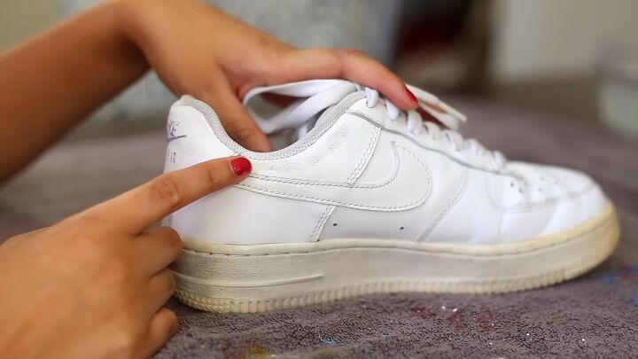 how to make sneakers white again making old yellow sneakers look new, Using the magic eraser on scuff marks