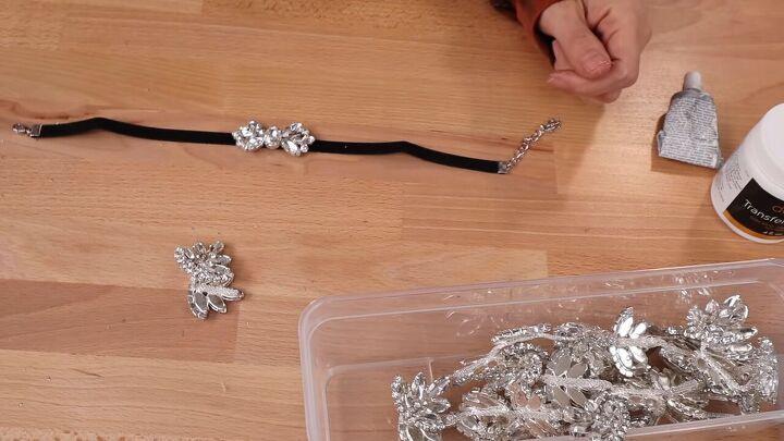 how to make glamorous diy rhinestone earrings chokers from scraps, Gluing a crystal piece to the choker