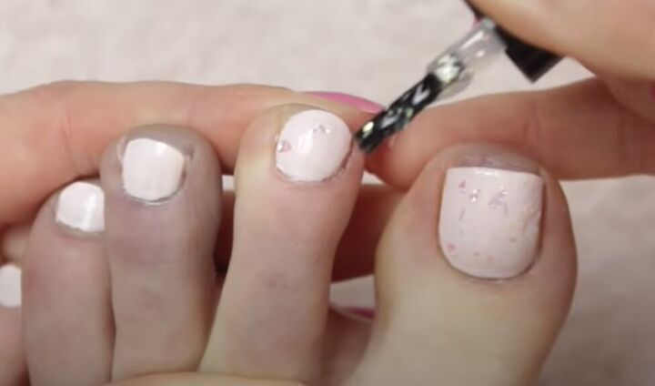 how to give yourself an amazing toenail makeover at home, Adding glitter nail polish on top of the color