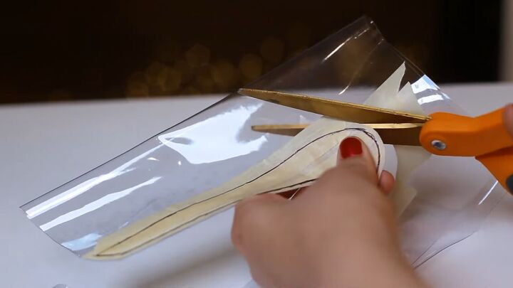 how to make a custom nike jelly swoosh with glitter baby oil, Cutting the Nike swoosh shape out of vinyl