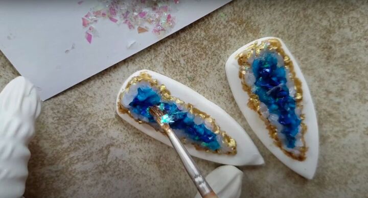 need some faux crystal earrings try this polymer clay geode tutorial, Painting UV resin onto the geode design