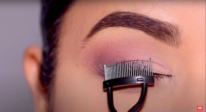 how to do seamless disappearing eyeliner for hooded eyes, Using a lash comb to separate lashes