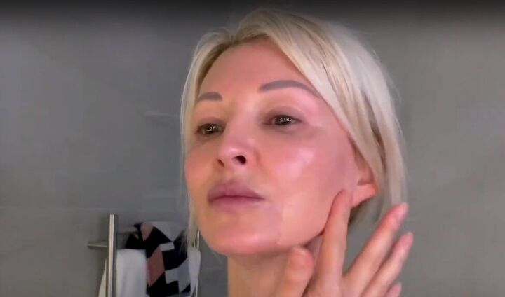 want an everyday glow try this natural makeup tutorial for over 50s, Applying a tinted serum to the face with fingers